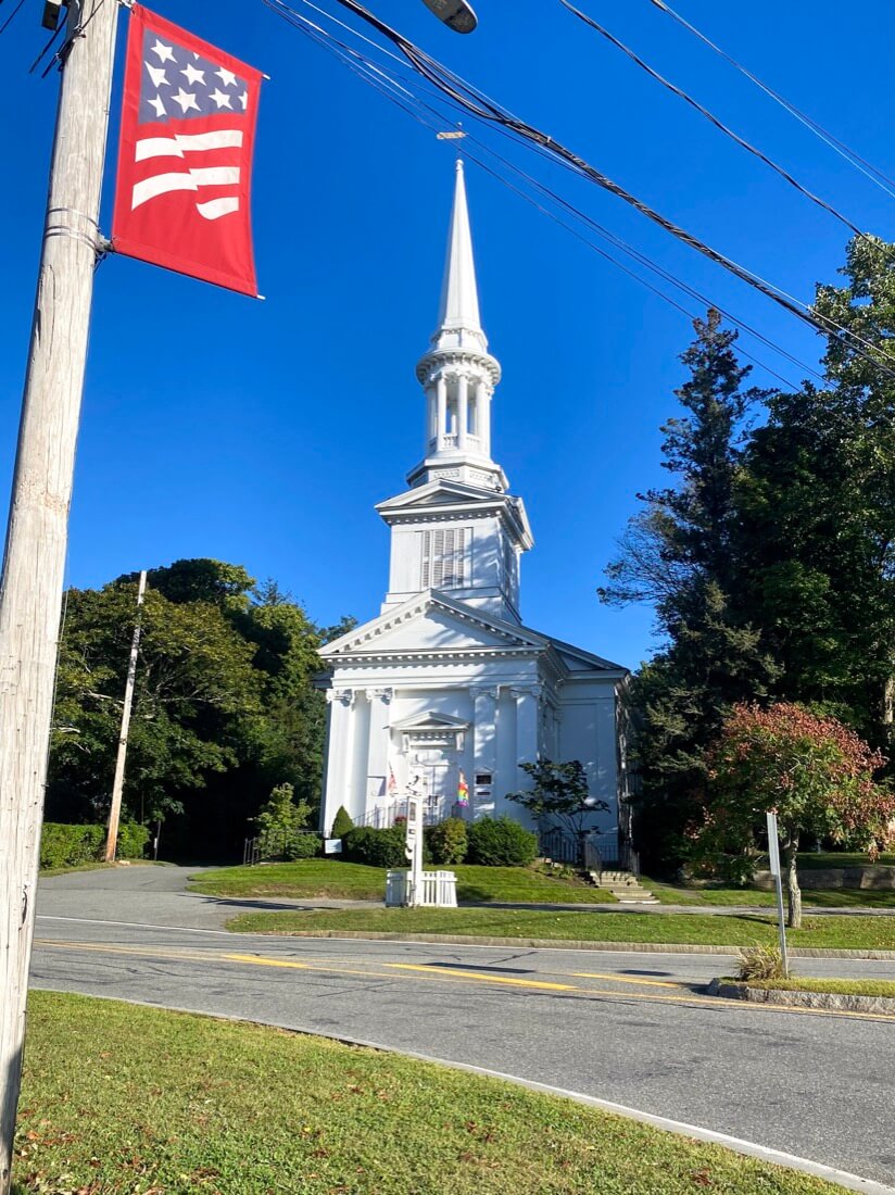 Church and US flag in Sandwich Cape Cod Massachusetts