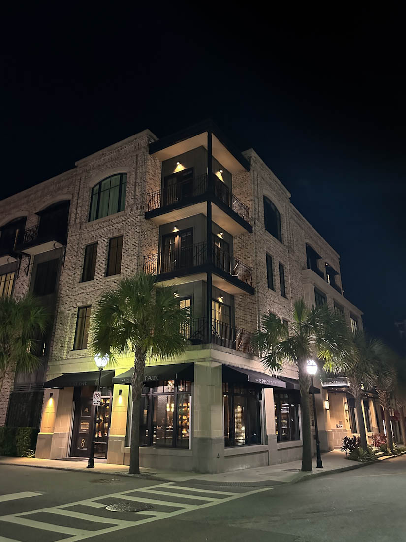 The Spectator Hotel lit up at night in Charleston